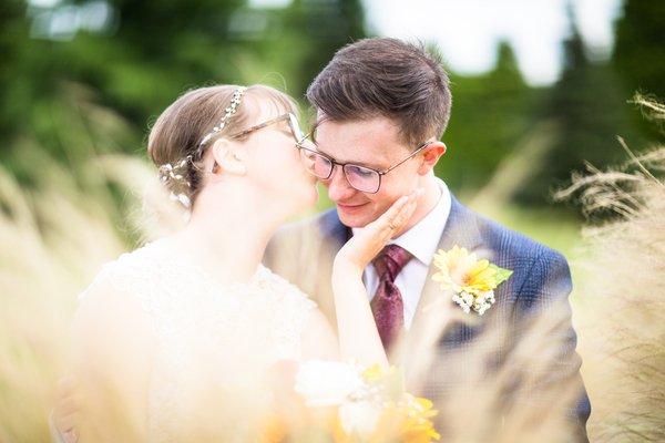 Maggie gives Callum a peck on the cheek as they sit together in the long grass.