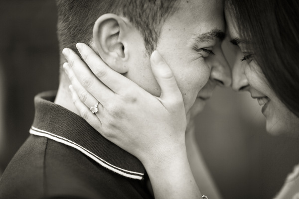 Engagement photo's of Laura & Mike. The couple embrace in front of graffiti. Laura tosses her head back in laughter in response to Mike's joke. 