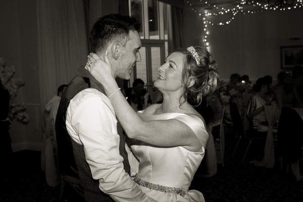 Keeley and Danny share a few words during their first dance. The darkened room melts into the background.